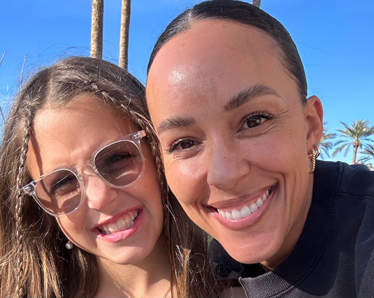 dawn numbrrrz owner with daughter smiling with blue background