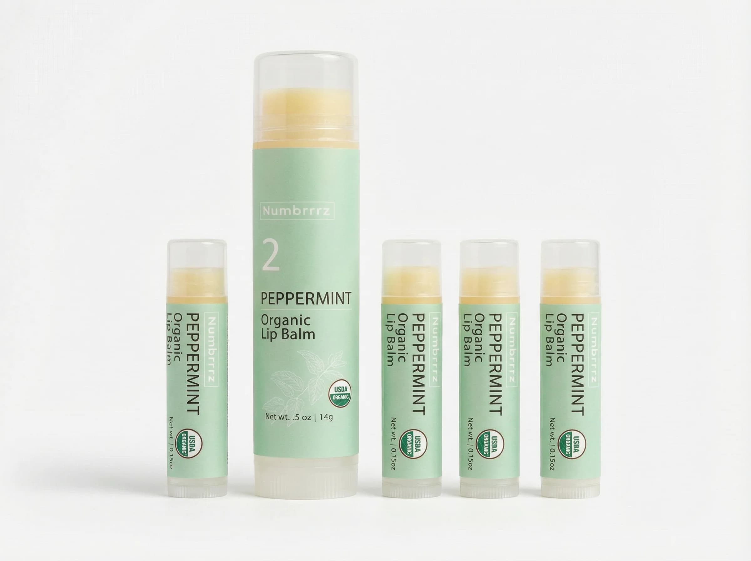 Numbrrrz 0.5oz tube next to four standard 0.15oz lip balms — 3.3x more product